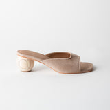 Beige open-toe sandal with a wooden heel on a light gray background