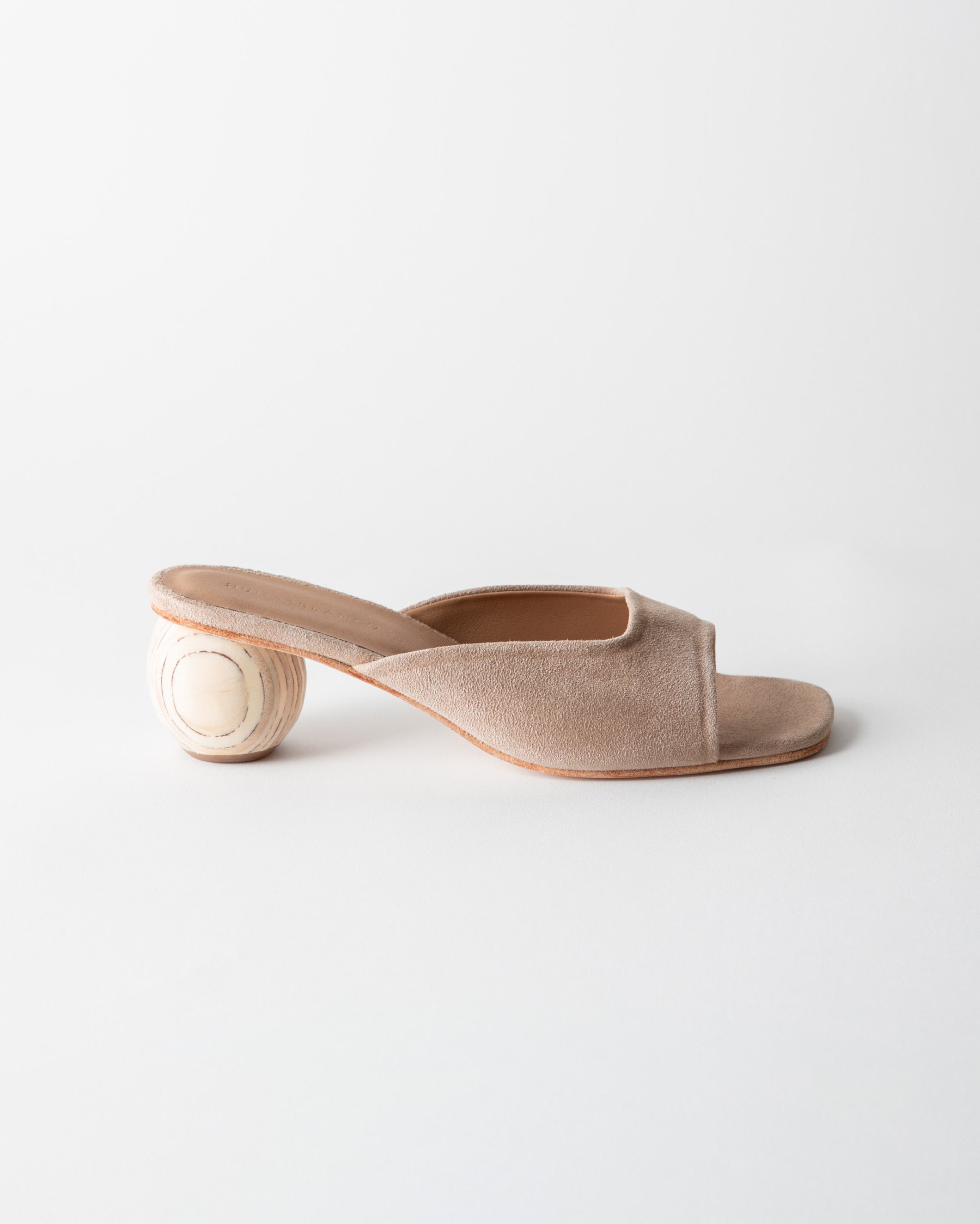 Beige open-toe sandal with a wooden heel on a light gray background