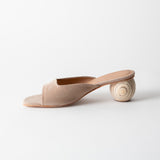 Beige open-toe sandal with a wooden heel on a light gray background