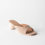 Beige open-toe sandal with a wooden heel on a light gray background
