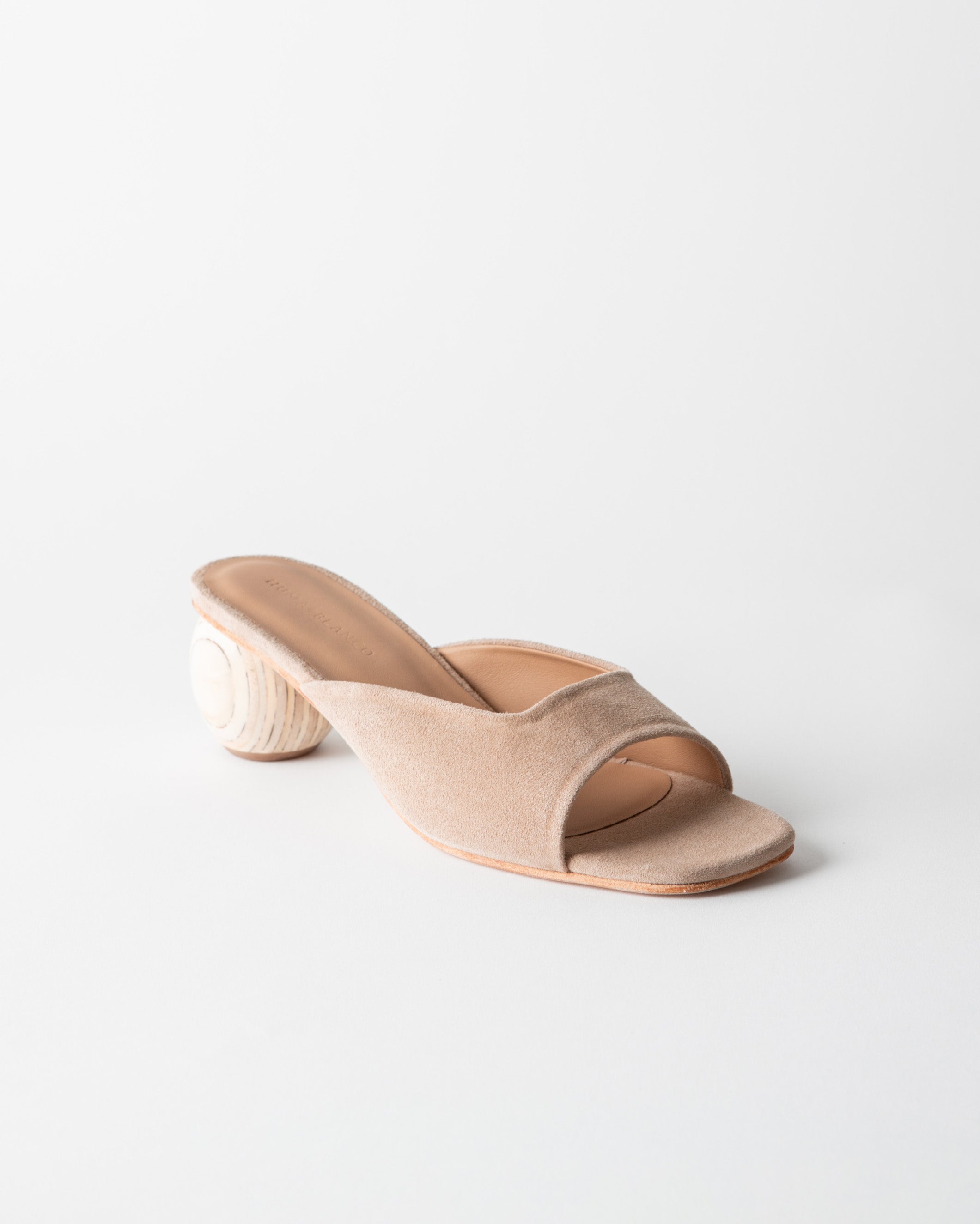Beige open-toe sandal with a wooden heel on a light gray background