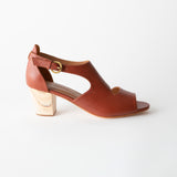 Brown sandal with a wooden block heel on a white background