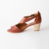 Brown sandal with wooden heel on a white background