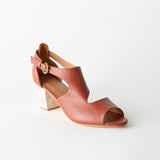 Brown sandal with a block heel on a white background