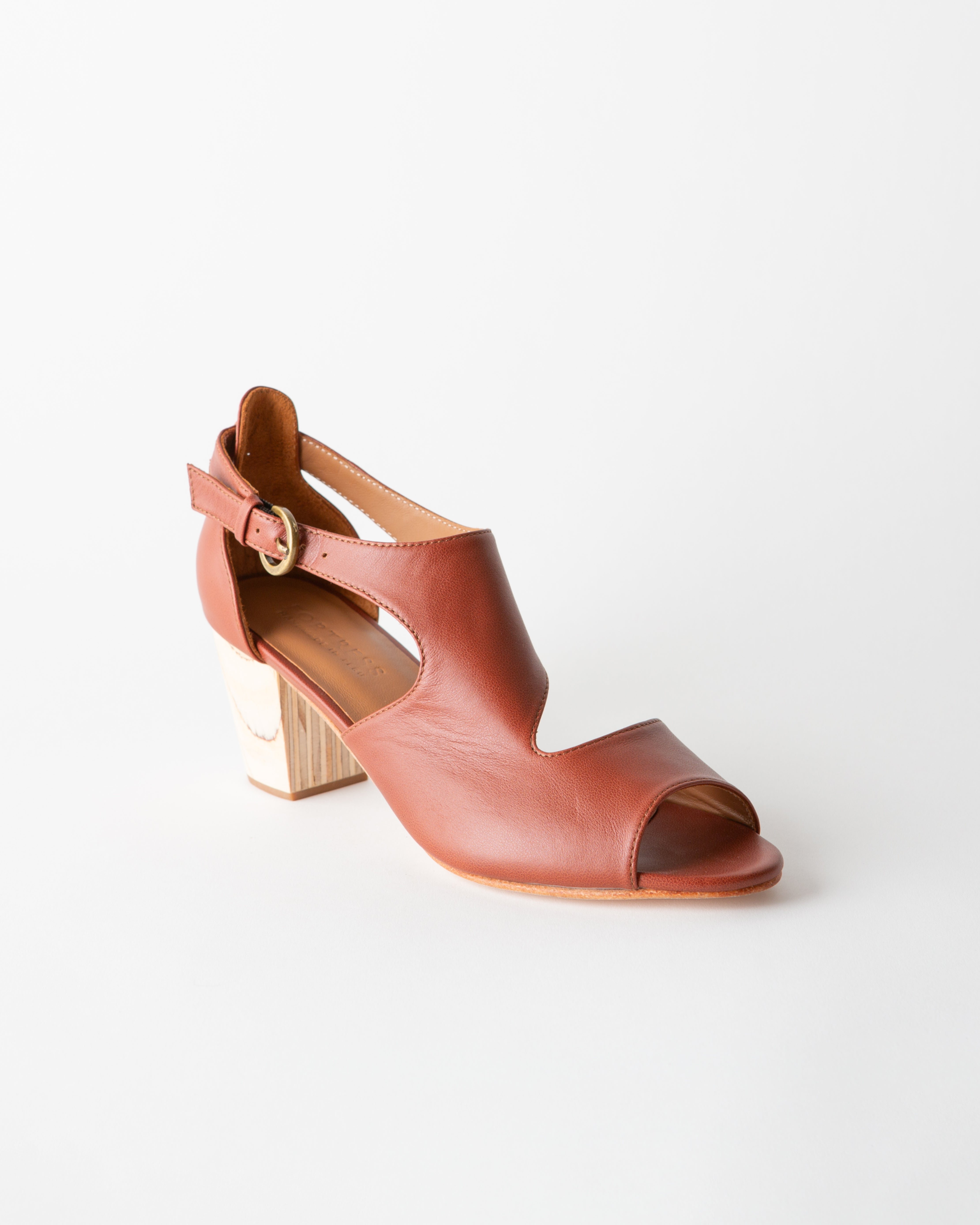 Brown sandal with a block heel on a white background