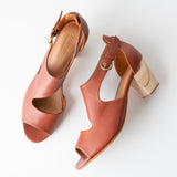 Pair of brown open-toe heels on a white background