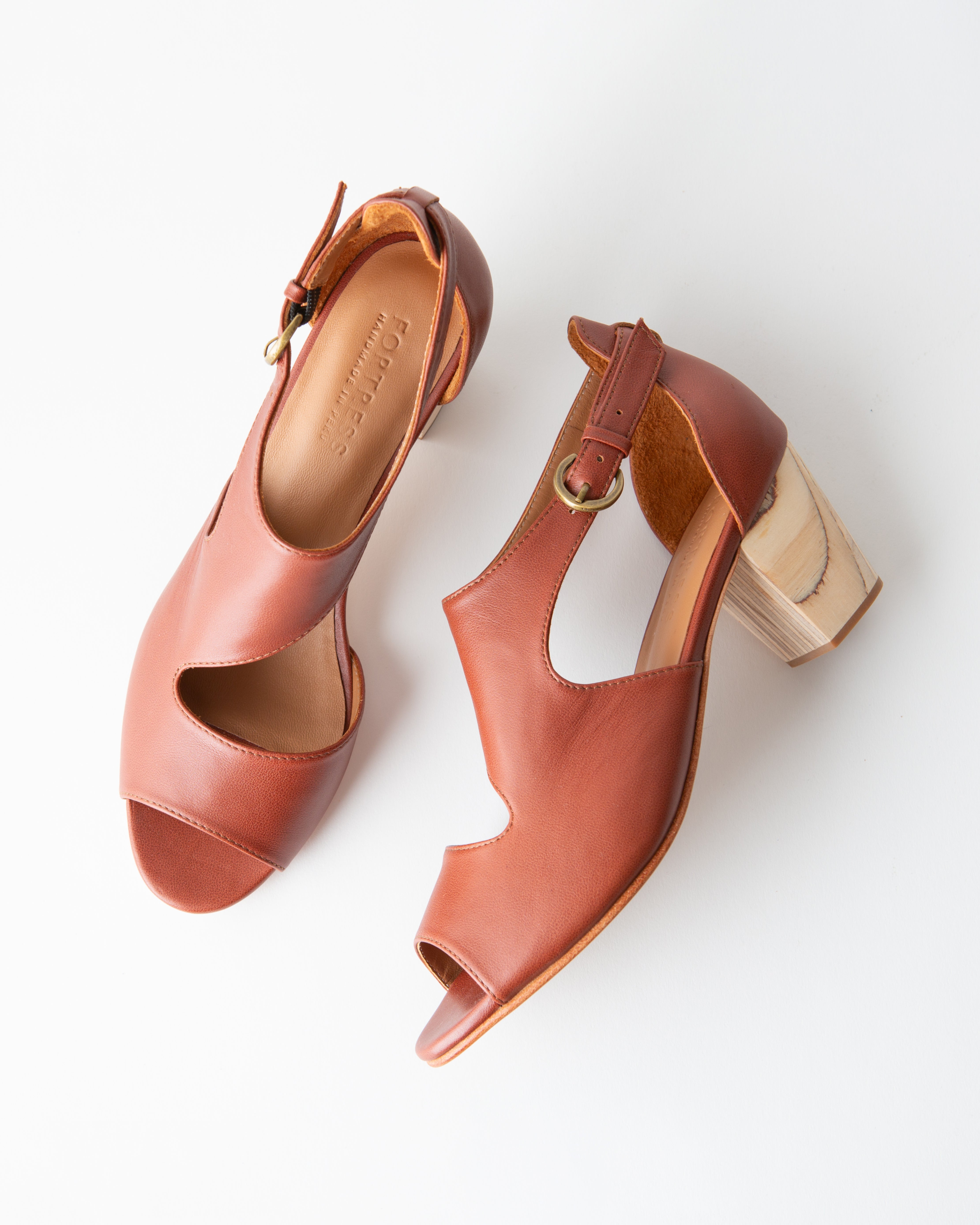 Pair of brown open-toe heels on a white background