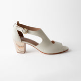 White sandal with a block heel on a white background