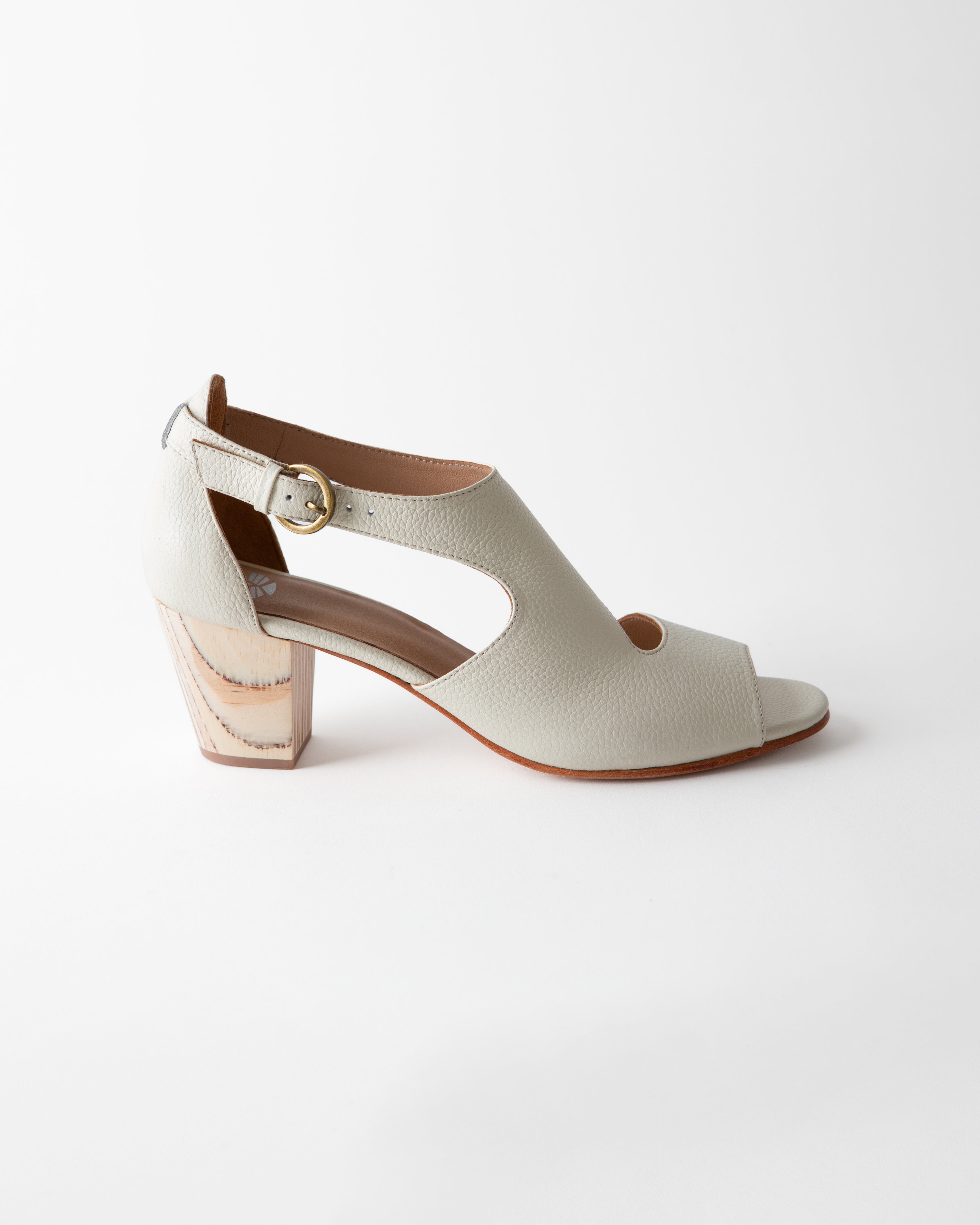 White sandal with a block heel on a white background