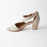 White sandal with a wooden heel on a white background