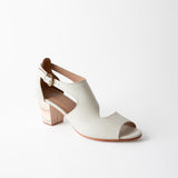 White sandal with a block heel on a white background