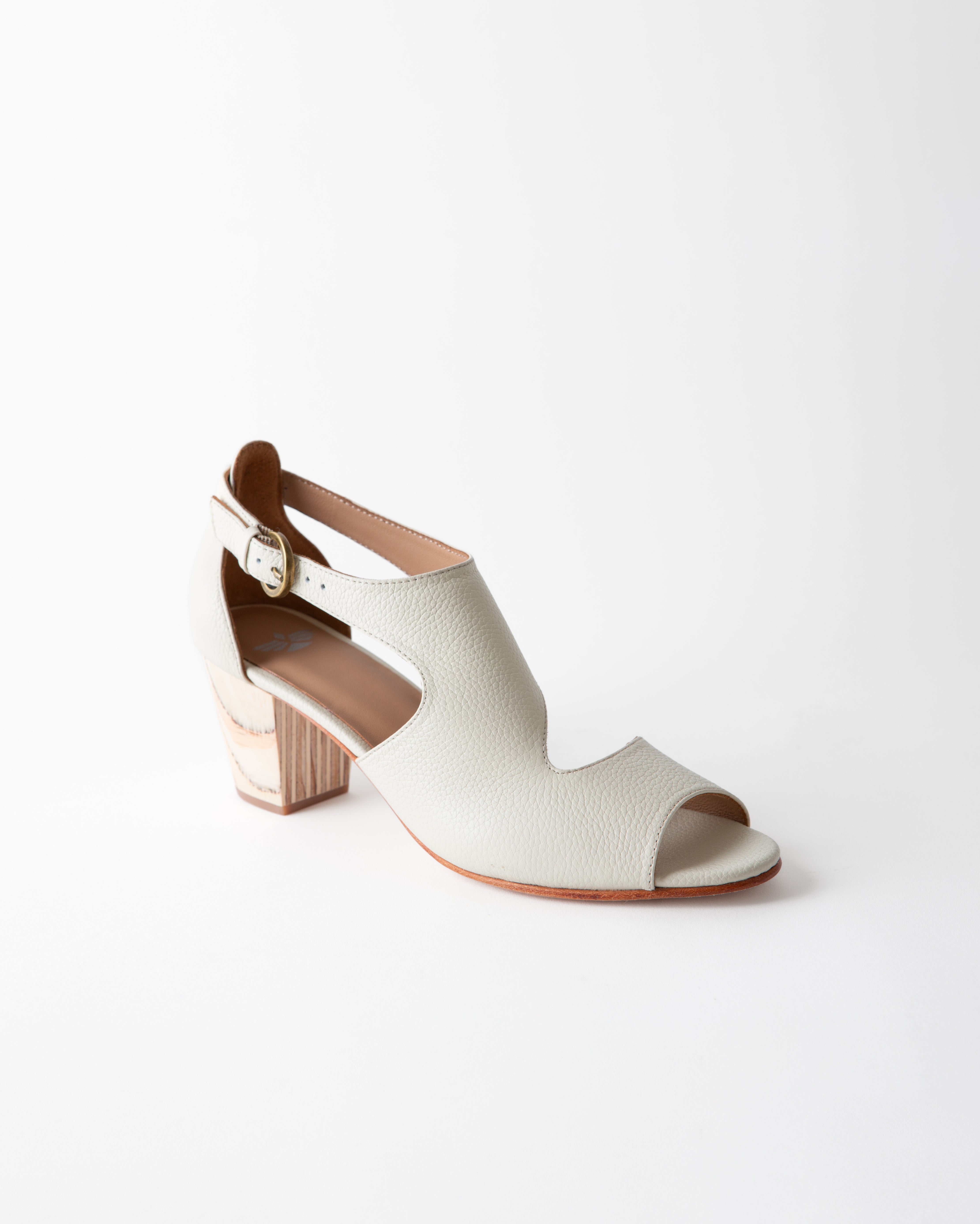 White sandal with a block heel on a white background